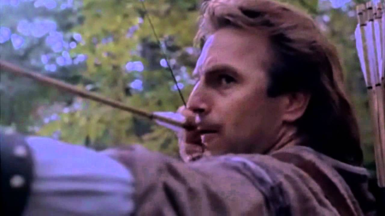 Kevin Costner as Robin Hood, taking aim in the woods